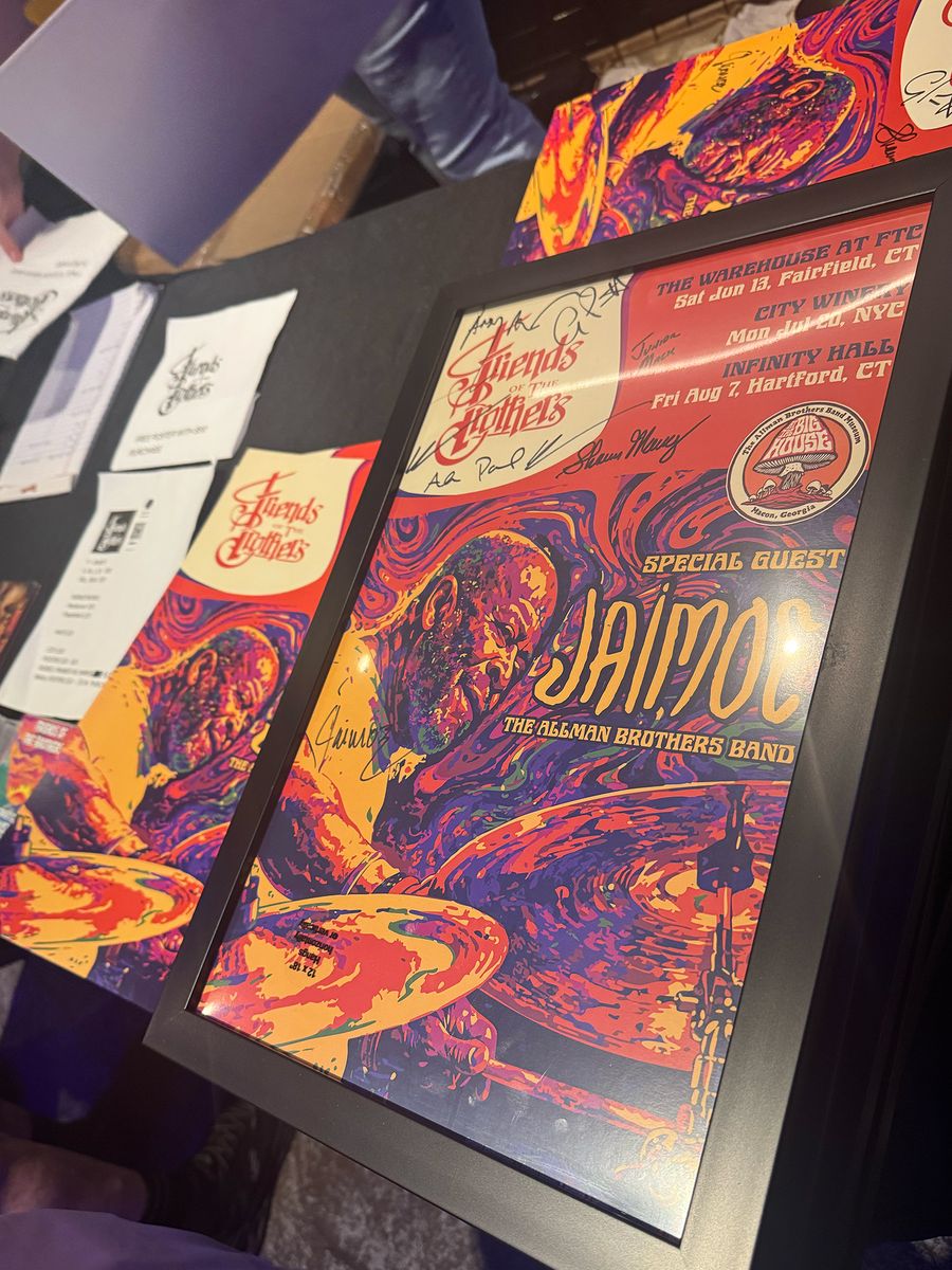 Friends of the Brothers merch booth — signed Jaimoe posters